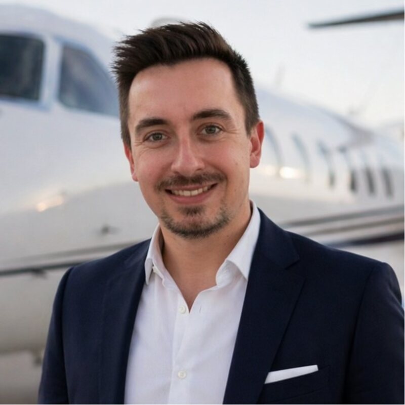 Oliver Smith-Aichbichler, Founder and CEO of AlbaJet, in front of a private jet